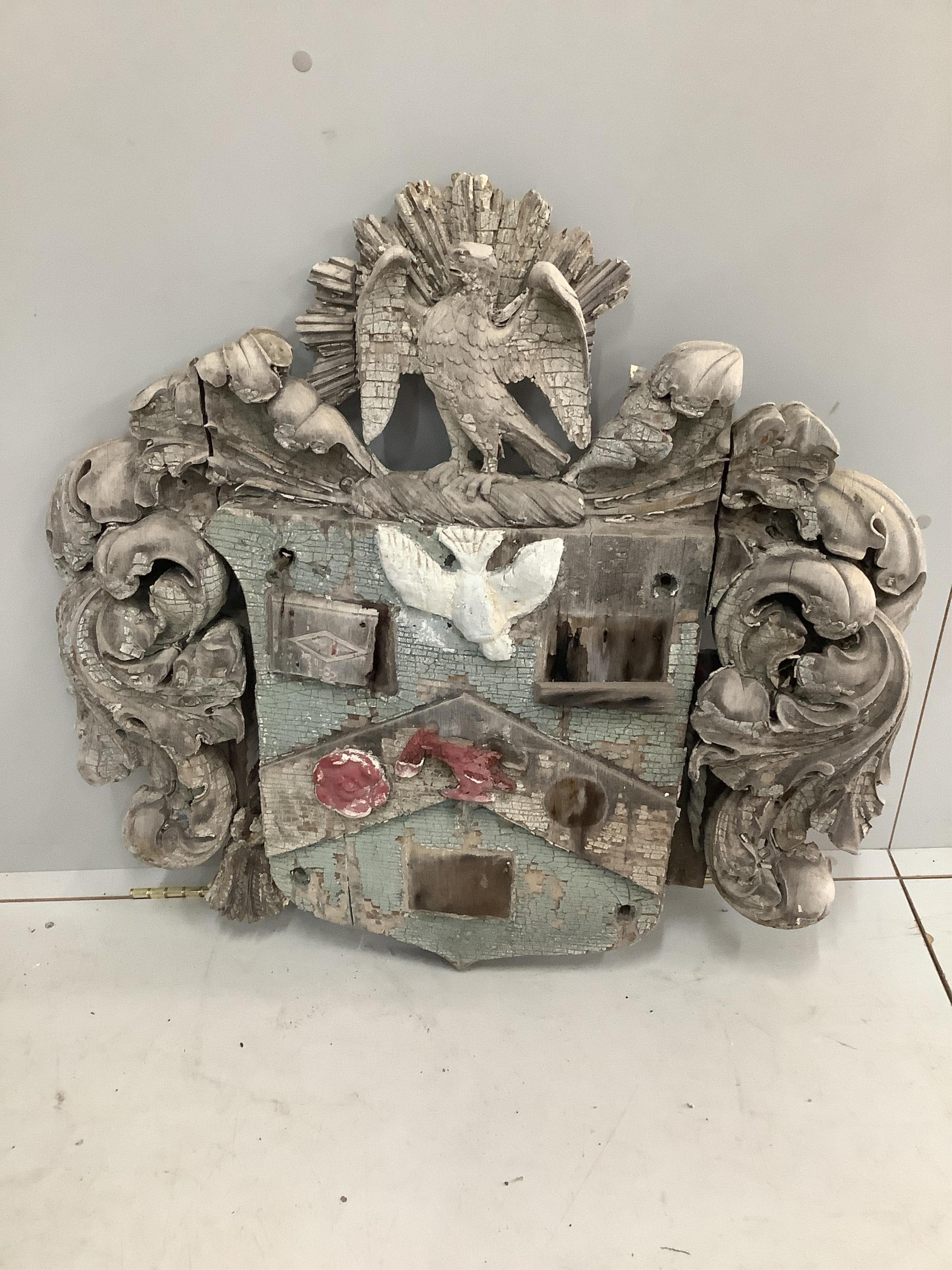 A carved painted wooden armorial, width 84cm, height 81cm. Condition - poor